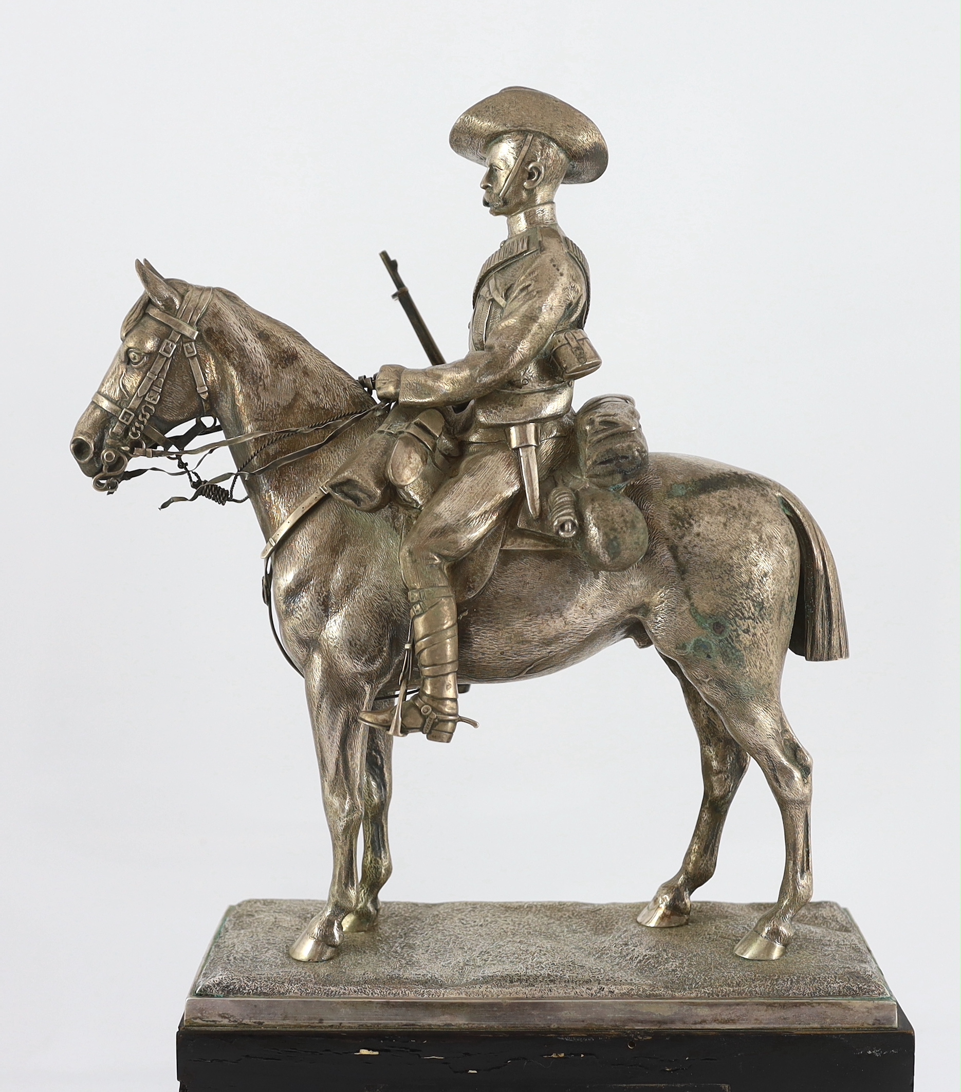 An early 20th century silver model of a City Imperial Volunteer, holding a rifle, on horseback, early 20th century